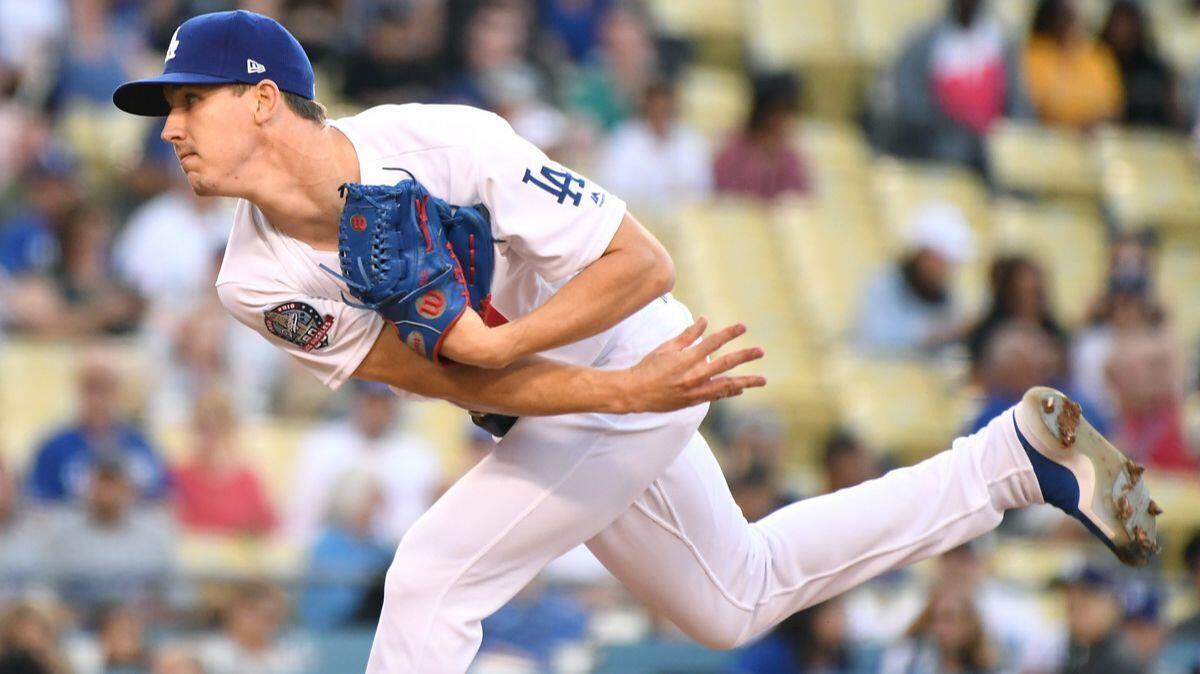 Dodgers pitcher Walker Buehler throws a pitch against the Atlanta Braves in the first inning at Dodger Stadium on Friday.