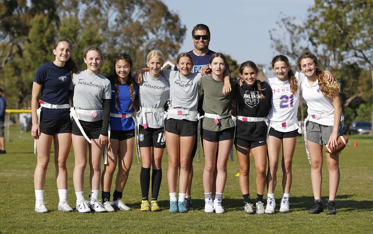 The Seals Football Club 13U team with coach Jason Guyser during practice at Mariners Park in Newport Beach on Wednesday.