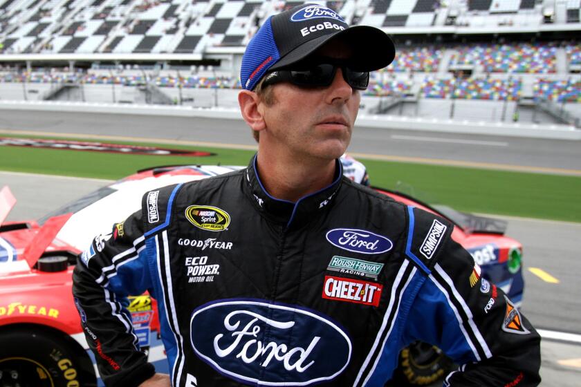 NASCAR driver Greg Biffle watches the scoreboard Friday only moments before it registered that he had won the pole for the Coke Zero 400.