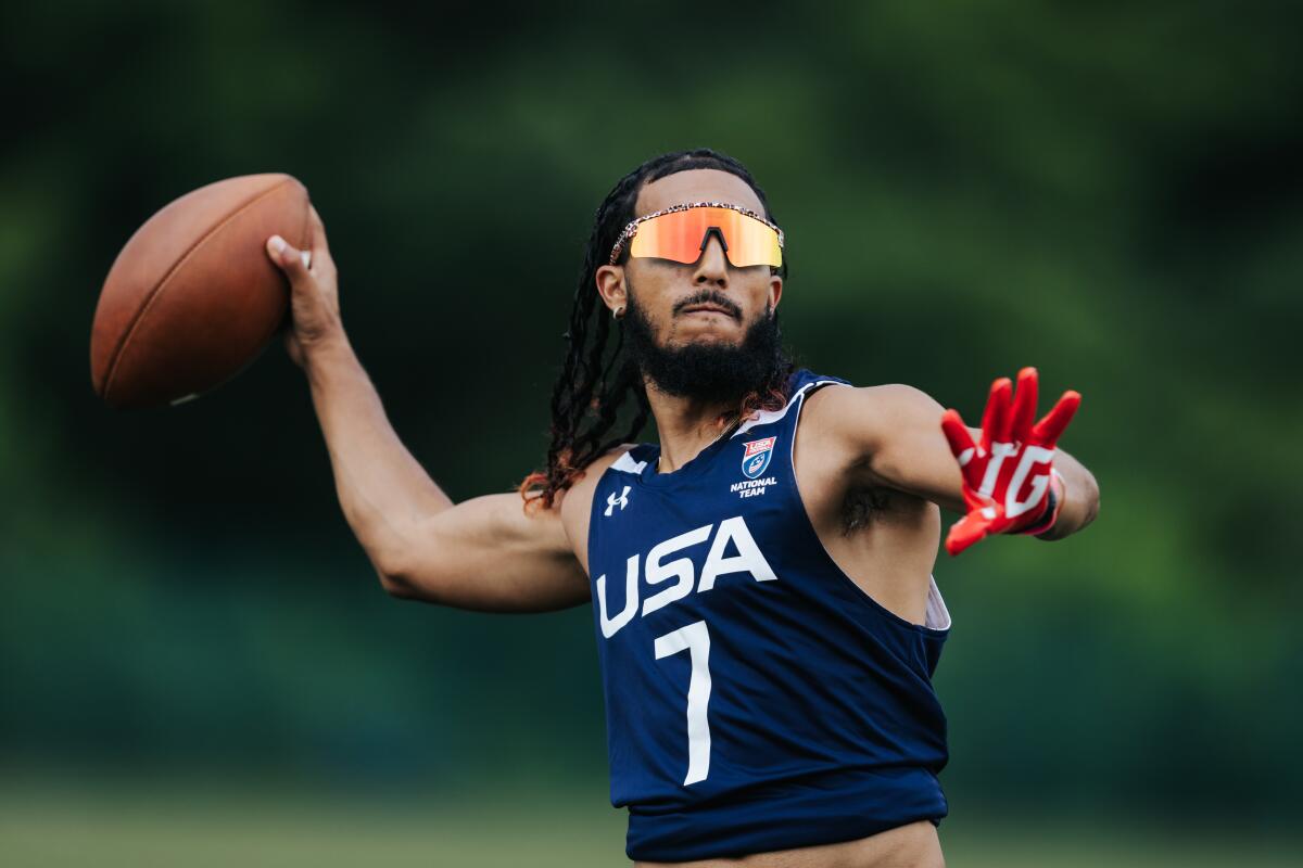 Darrell 'Housh' Doucette throws a football.