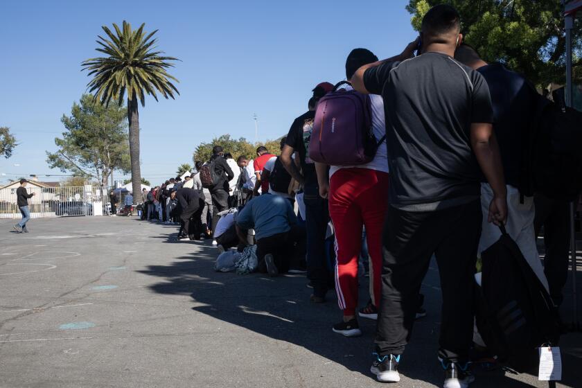 San Diego, CA - December 06: Migrants are offered a warm meal, charging port and other services at an undisclosed location in central San Diego on Wednesday, Dec. 6, 2023 in San Diego, CA. SBCS, a nonprofit formerly known as South Bay Community Services, runs the site that currently has about 800 migrants daily. San Diego board of Supervisors voted to allocate $3 million in funding to help support asylum-seeking migrants in the county Tuesday. (Ana Ramirez / The San Diego Union-Tribune)