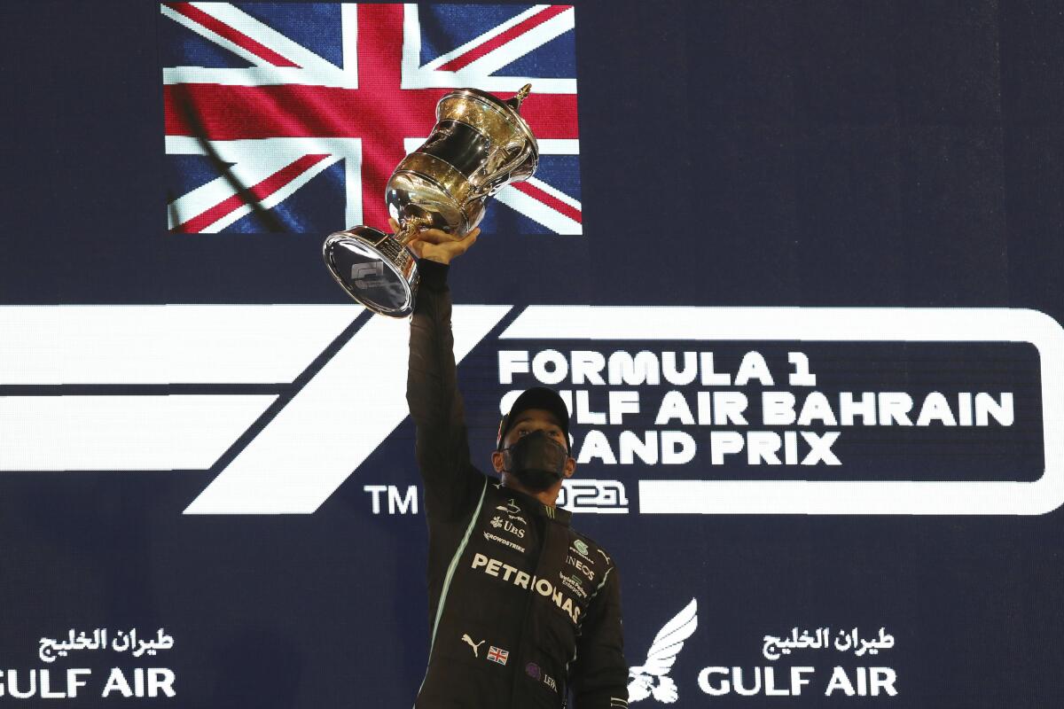 Lewis Hamilton celebrates on the podium.