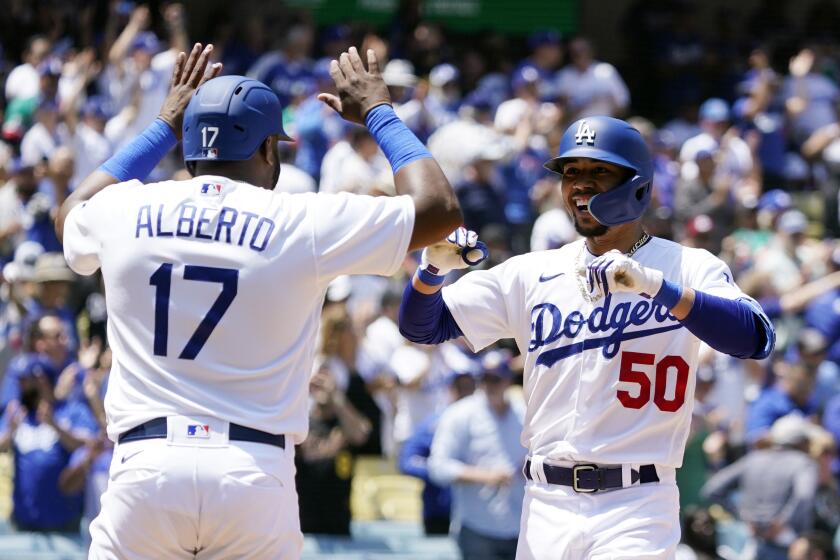 Los Angeles Dodgers' Mookie Betts celebrates his two-run home run with Hanser Alberto (17) during the sixth inning of the first game of a baseball double-header against the Arizona Diamondbacks Tuesday, May 17, 2022, in Los Angeles. (AP Photo/Marcio Jose Sanchez)