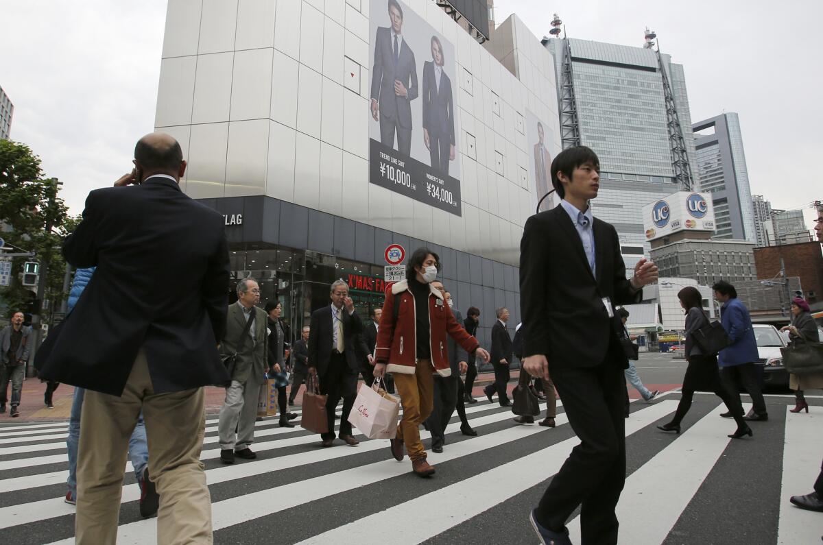 People walk on a pedestrian crossing in Tokyo on Nov. 17.