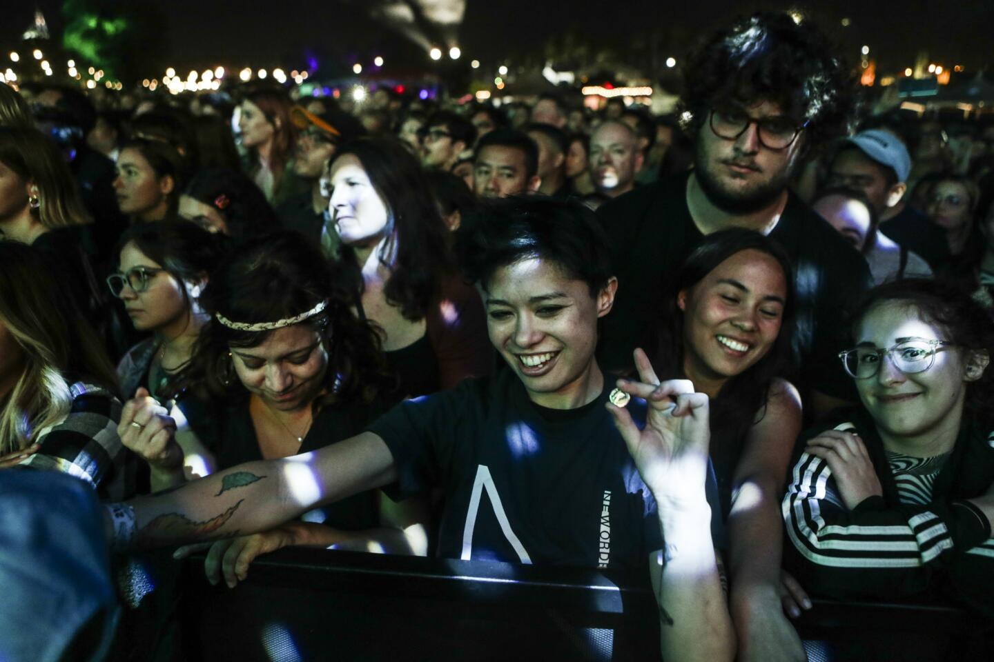 A large crowd is seen for New Order, a veteran synth rock band.