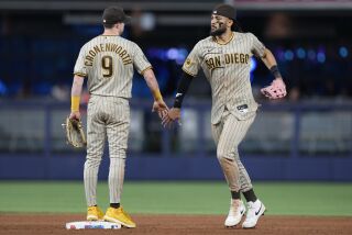 Padres right fielder Fernando Tatis Jr. and second baseman Jake Cronenworth celebrate after a victory the Marlins 