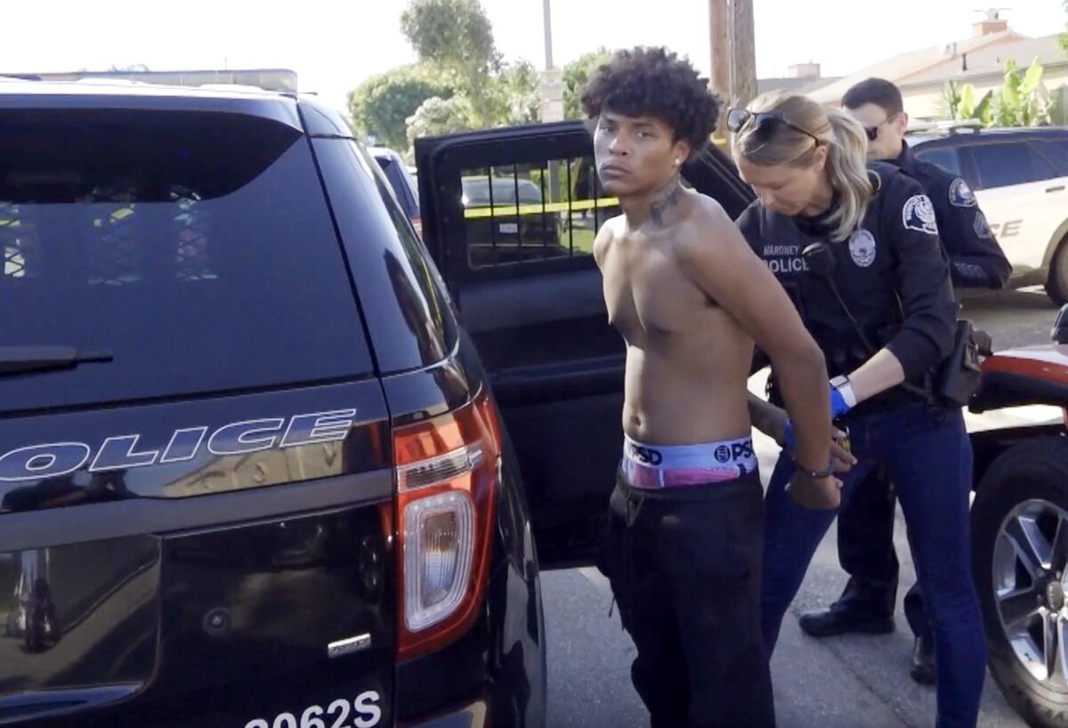 Newport Beach police take a shirtless man into custody.