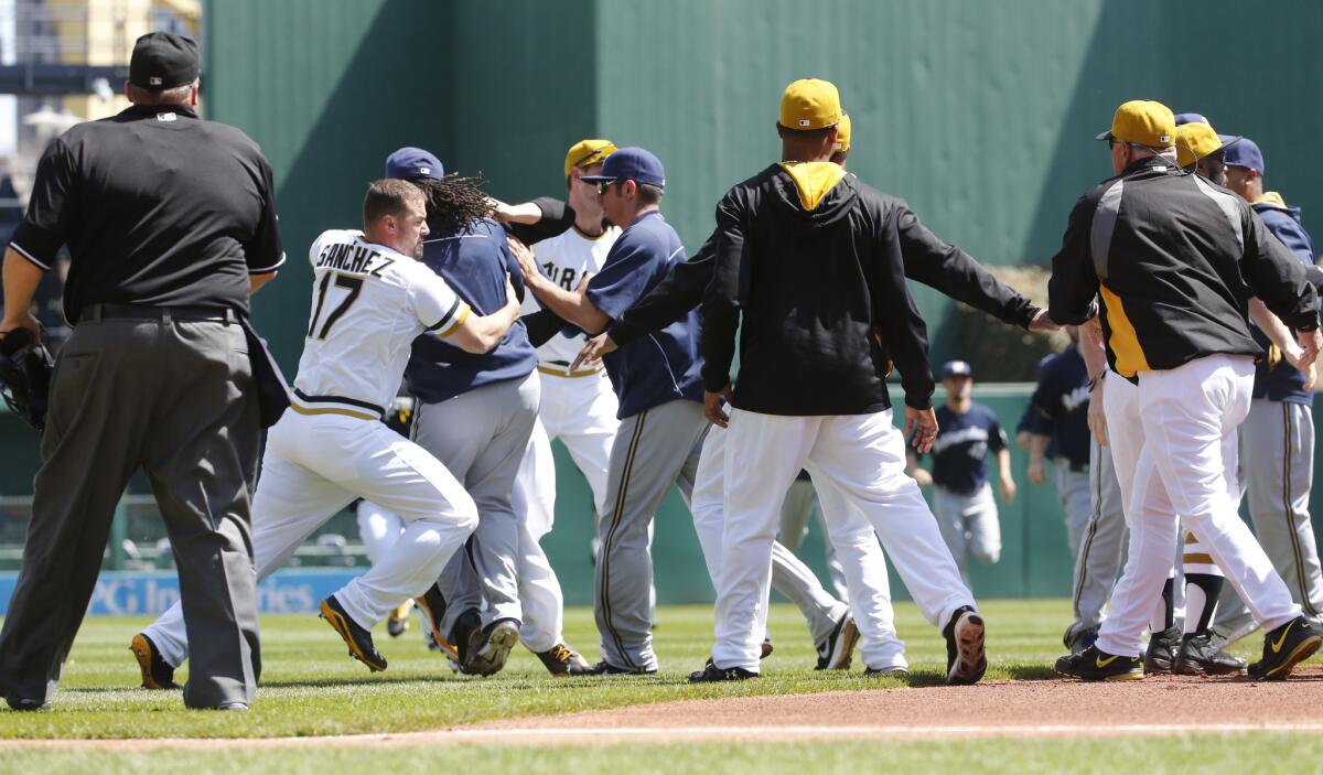 Pittsburgh Pirates and Milwaukee Brewers players fight during the third inning of Sunday's game in Pittsburgh.