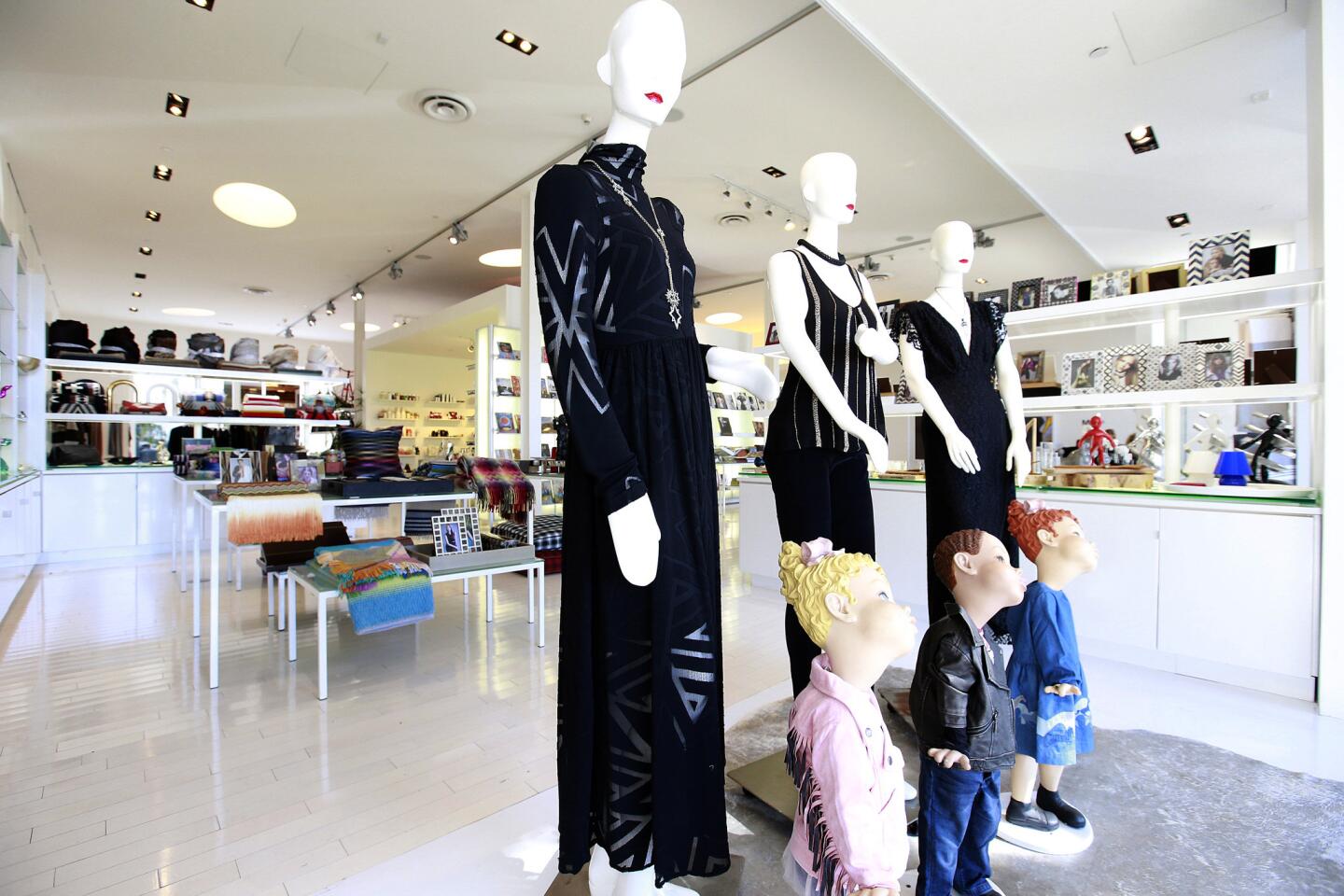 Fashion kids and womens wear on display in the front window.