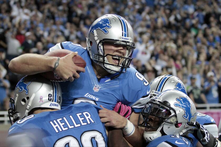 Detroit Lions quarterback Matthew Stafford (9) celebrates his touchdown run in 2012.