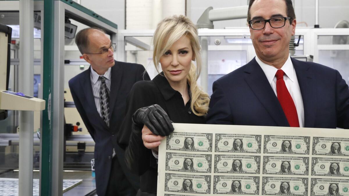 Treasury Secretary Steven T. Mnuchin, seen here with his wife, placed assets worth at least $32.9 million into the Steven Mnuchin Dynasty Trust I, according to a disclosure to federal ethics officials made public last year.