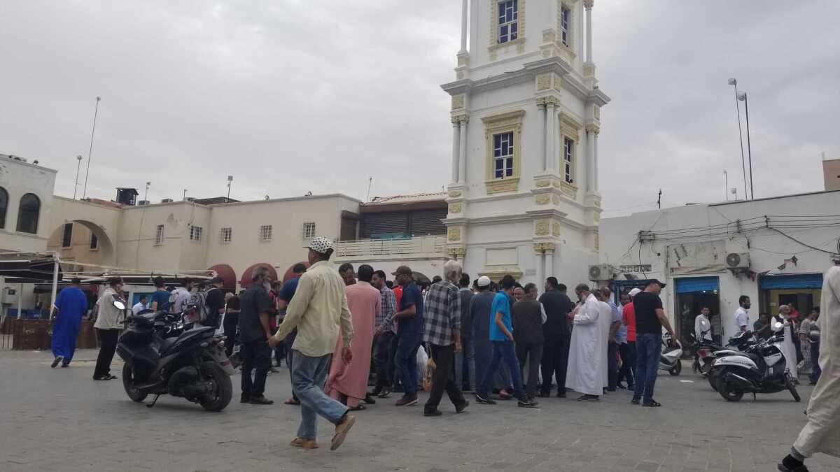 A helga, or circle of unlicensed currency traders, at Musheer market in Tripoli, Libya.