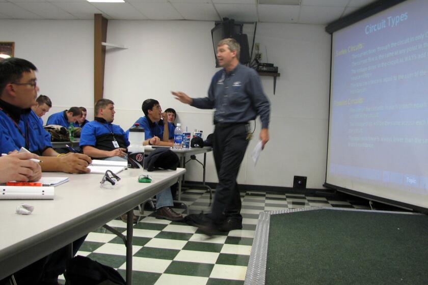 In this June 2009 file photo, Larry Wostenberg teaches an engine management systems class at the WyoTech technical school campus in Laramie, Wyo. WyoTech's parent company, Orange County-based Corinthian Colleges, on Thursday said it's in danger of shutting down.