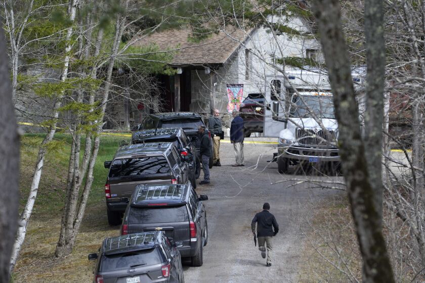 FILE - Investigators work at the scene of a shooting where four people were killed on April 18, 2023, in Bowdoin, Maine. State police have released heavily redacted transcripts of 911 calls from the day of the shootings. (AP Photo/Robert F. Bukaty, File)
