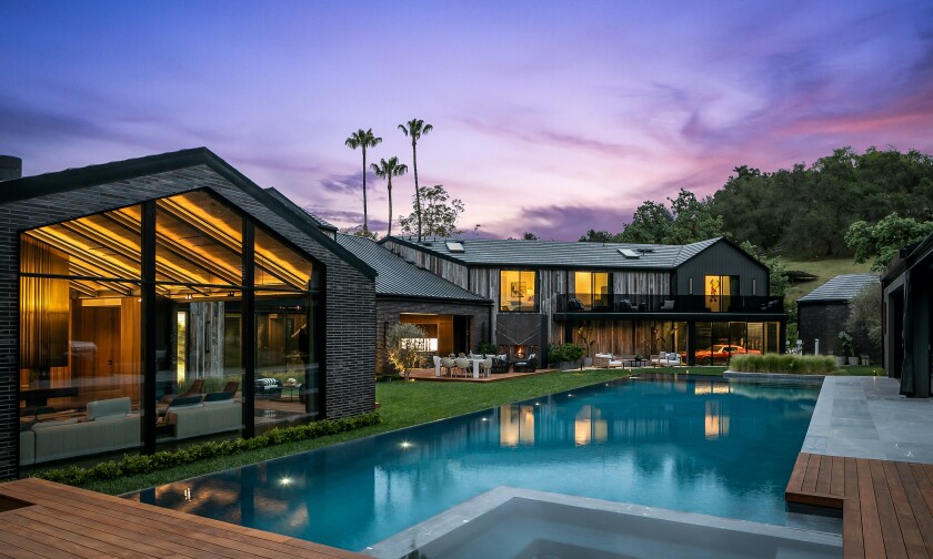 The bold black farmhouse was built in 2021 and includes a swimming pool and guest house.