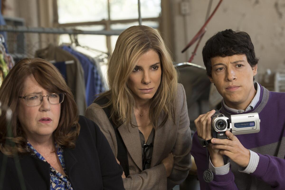 Ann Dowd, left, as Nell, Sandra Bullock as Jane and Reynaldo Pacheco as Eddie in Warner Bros. Pictures and Participant Media's satirical comedy "Our Brand Is Crisis," a Warner Bros. Pictures release.