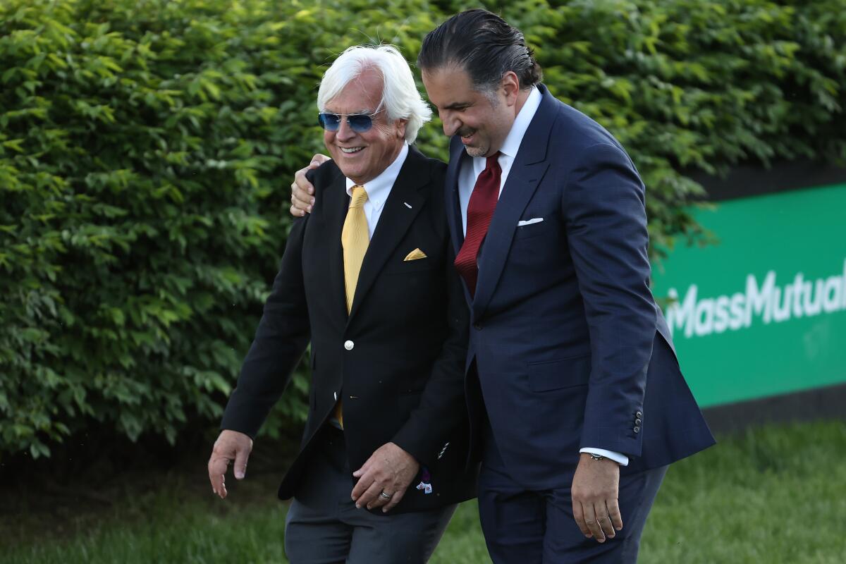 Horse trainer Bob Baffert and Medina Spirit owner Amr Zedan celebrate after winning the Kentucky Derby last year.