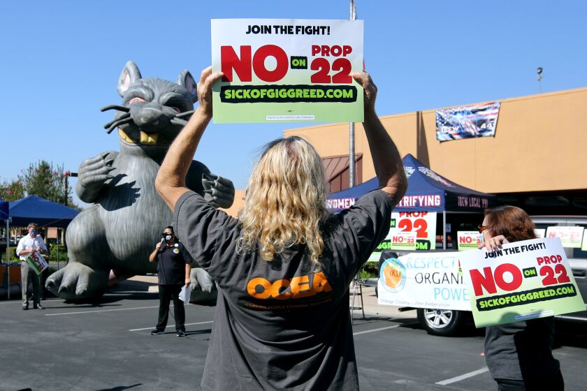 Speakers gave their message next to a large blow up rat, signifying the greedy owners of ride-share companies according to a person present at the event, at press conference about voting no on proposition 22, in solidarity with Uber and Lyft drivers, at the IBEW headquarters in the city of Orange on Friday, Oct. 16, 2020.