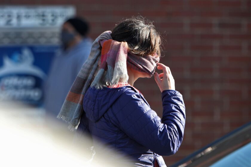 A customer wears a scarf as face protection at Trader Joe's, on E. Glenoaks Blvd., in Glendale on Tuesday, April 14, 2020.