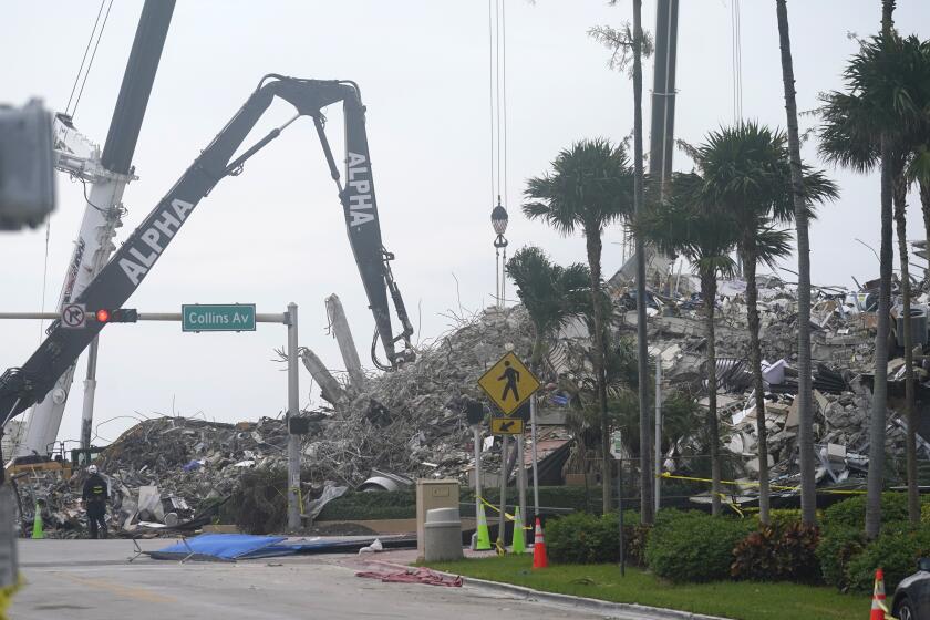 Rescue crews work in the rubble of the collapsed Champlain Towers South condominium building, Tuesday, July 6, 2021, in Surfside, Fla. (AP Photo/Lynne Sladky)