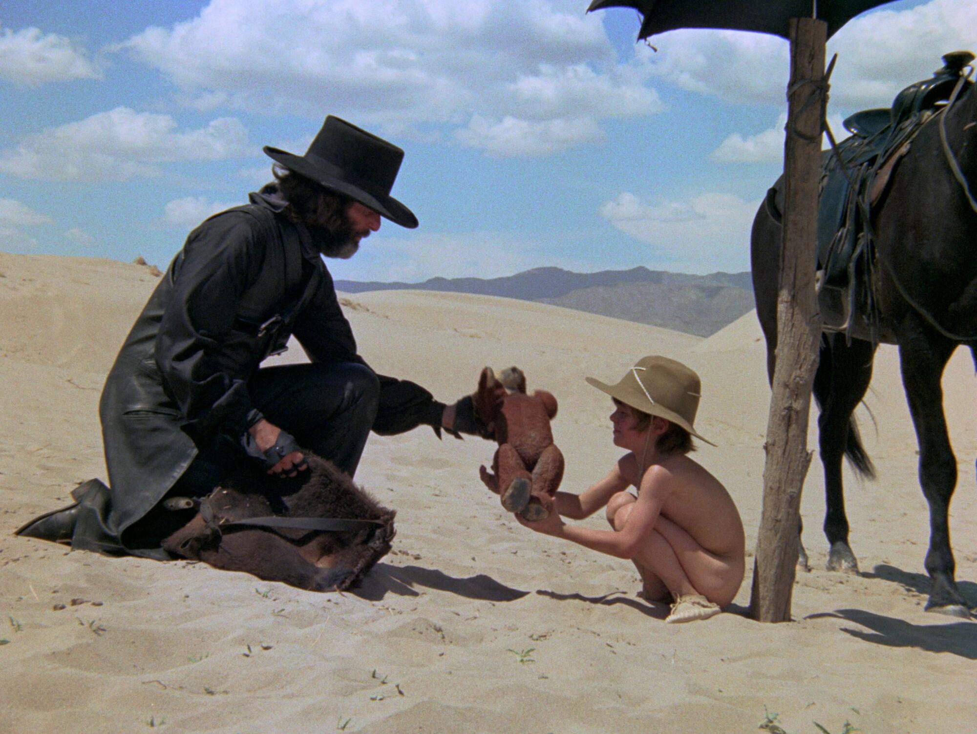 A man in a black hat connects with a boy.