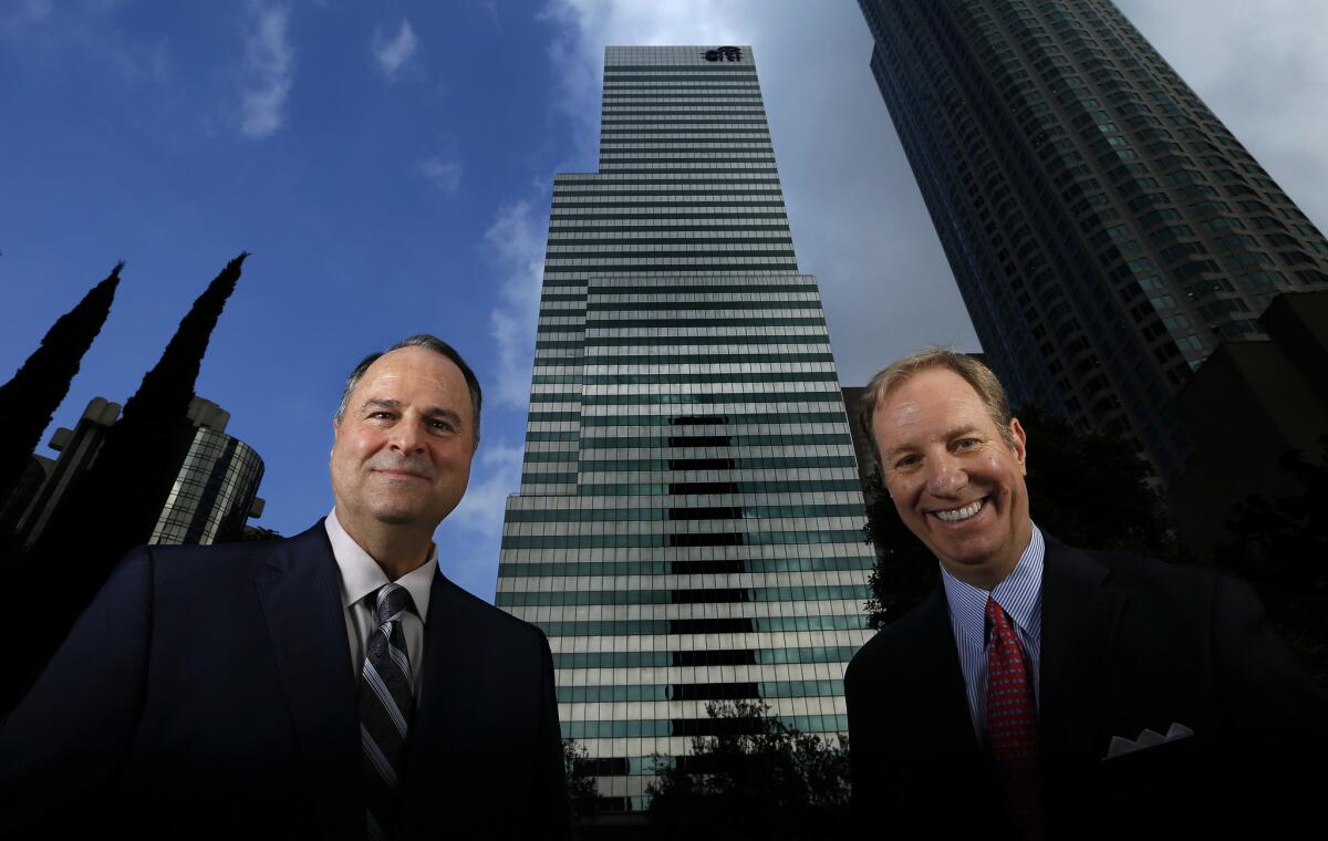 Thomas Ricci, left, and John Sischo, managing principals at Coretrust Capital Partners, are the new owners of the Citigroup Center, shown in the center background. They plan a $50-million renovation of the 1980s-era building.