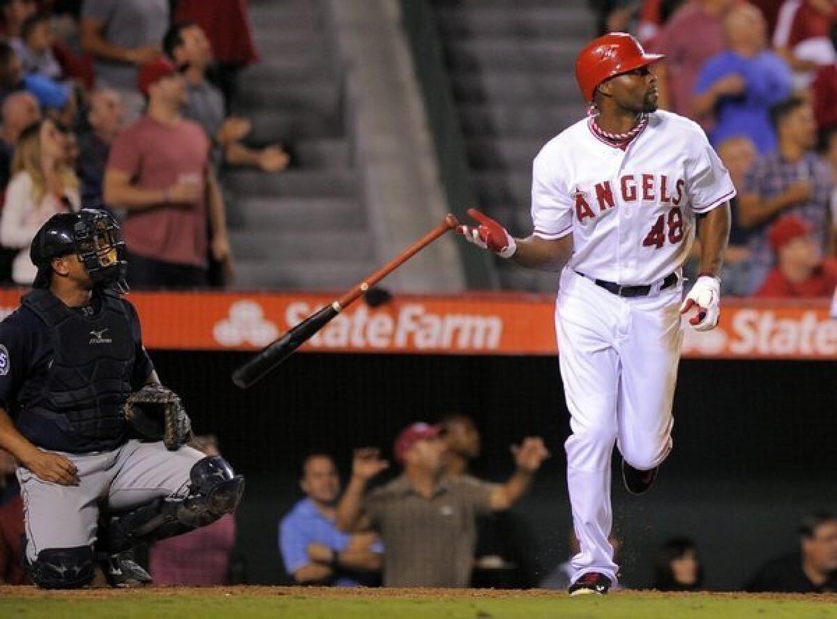 Torii Hunter drops his bat as he hits a two-run home run.