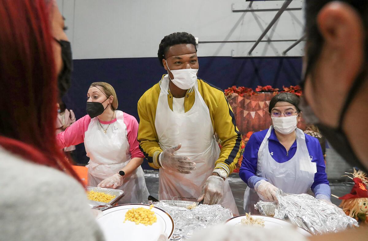 Los Angeles Chargers football star Derwin James joins fellow volunteers.