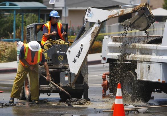 Crews work on a broken water line after the quake.