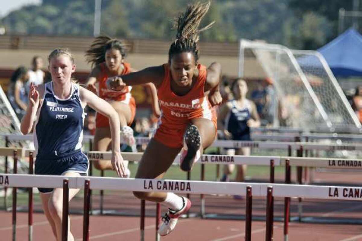 Pasadena Poly's Simone Abegunrin runs in the hurdles event during a tri-Prep League track and field meet between the Panthers, Flintridge Prep and Westridge.