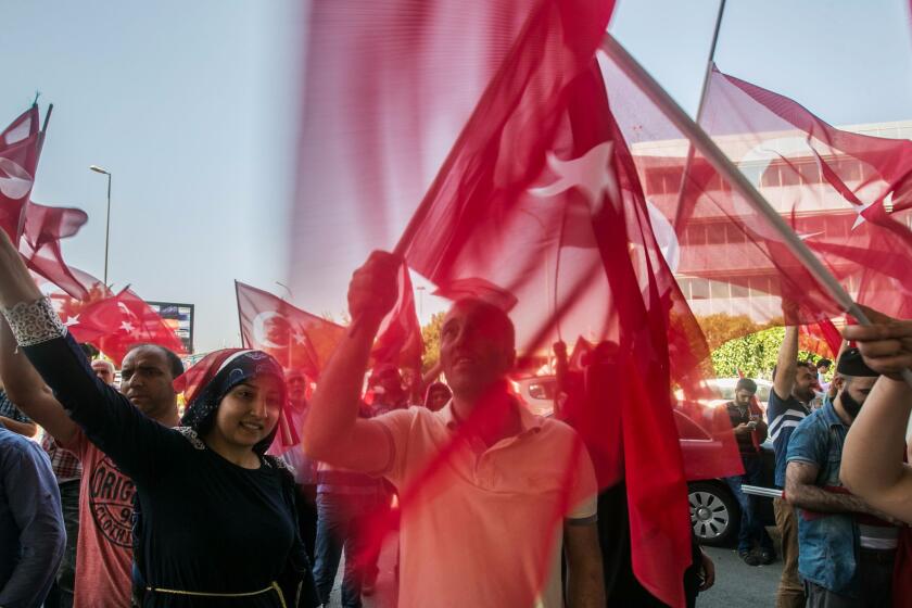 Turks wave flags at the Ataturk airport in Istanbul as they celebrate defeating a coup attempt.