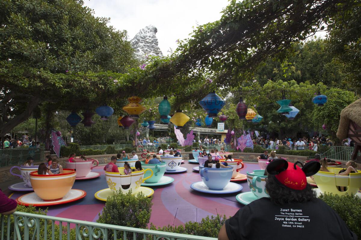 Visitors ride the Mad Tea Party cups at Disneyland in June 2015.