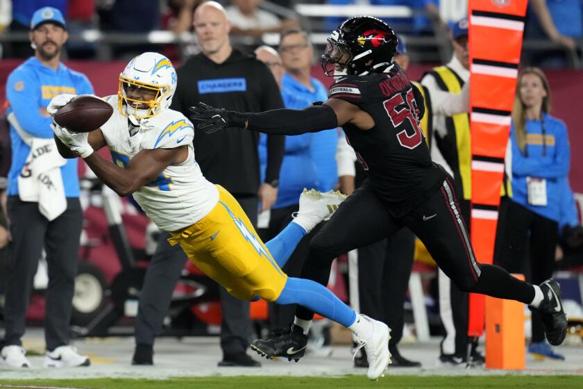  The Chargers' Stone Smartt (84) cannot hold on to this pass behind Cardinals linebacker Julian Okwara (58).