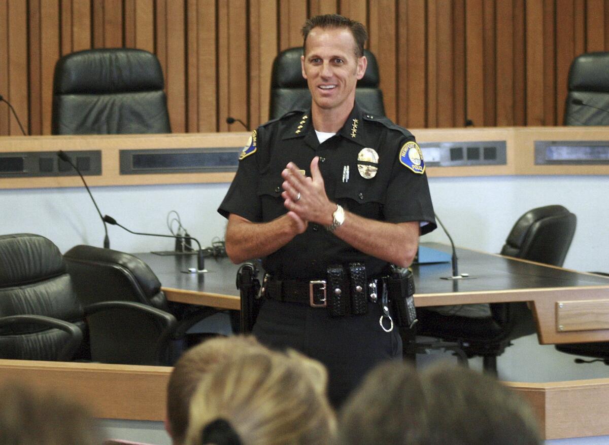 Attorneys for a former Newport Beach police dispatcher asked a judge to dismiss her sexual-harassment complaint against Chief Jay Johnson, shown above in a file photo.