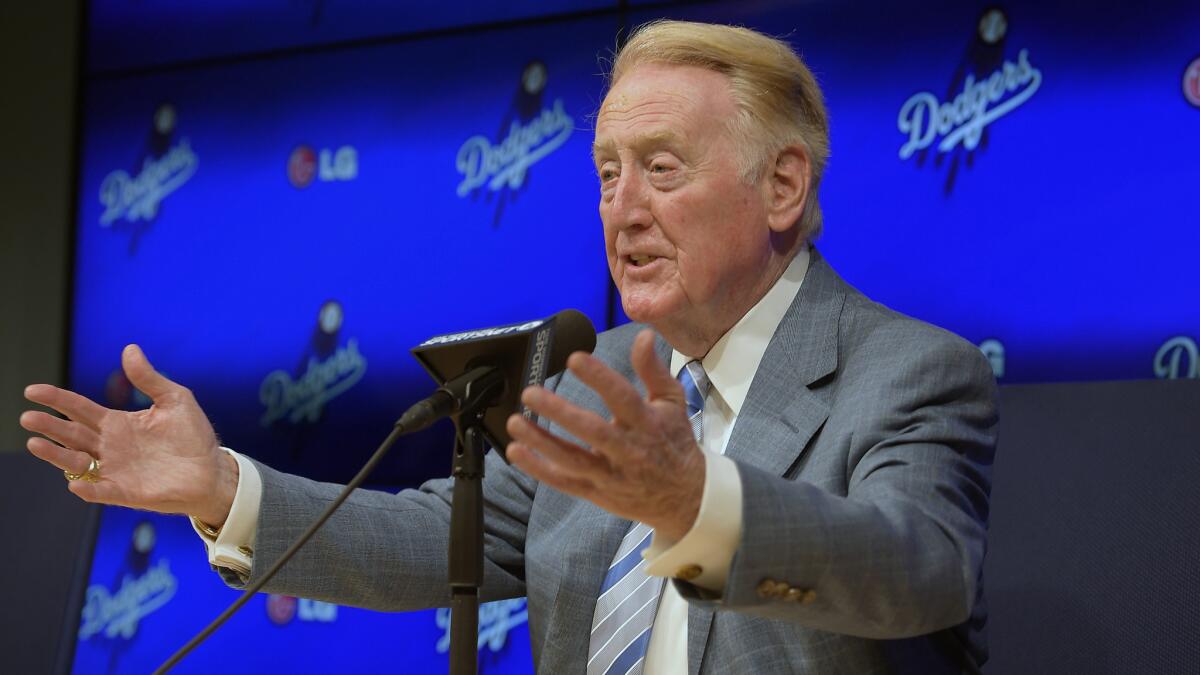 Dodgers announcer Vin Scully speaks about his decision to come back for a 66th season in the broadcast booth during a news conference Wednesday at Dodger Stadium.