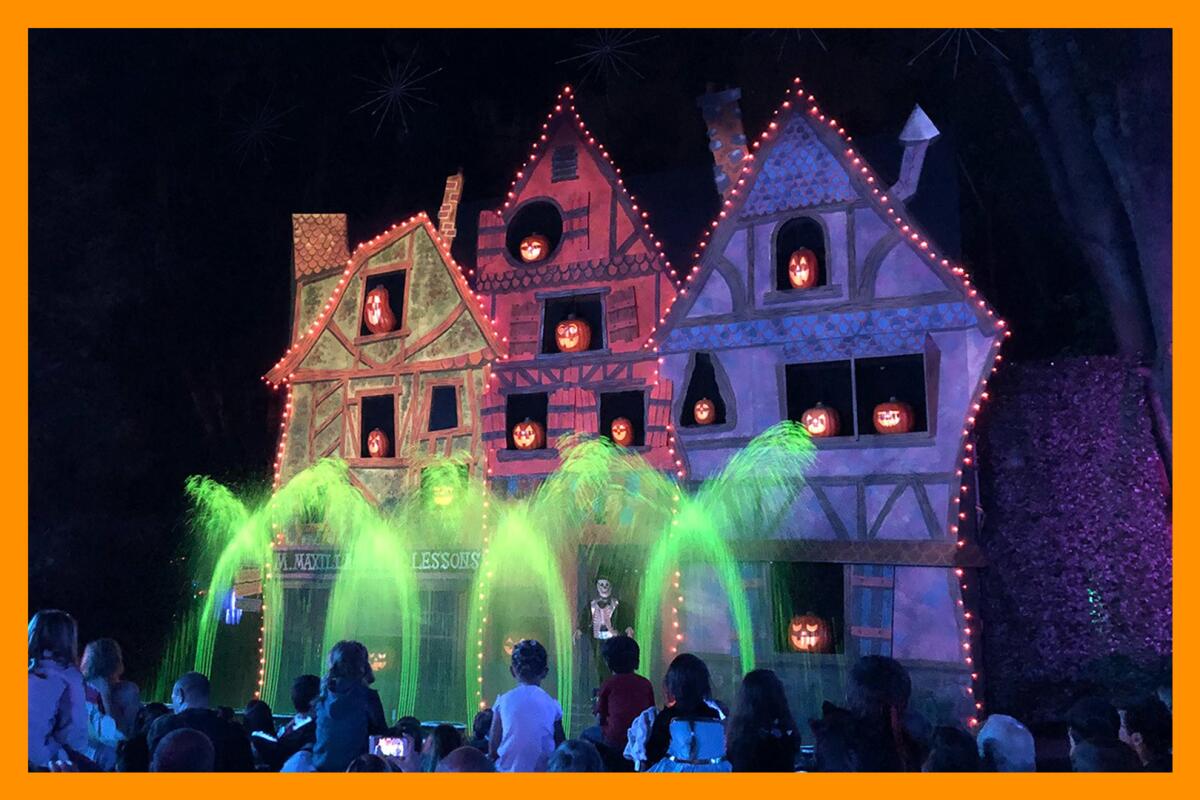 Spooky houses in the dark decorated with brightly colored lights