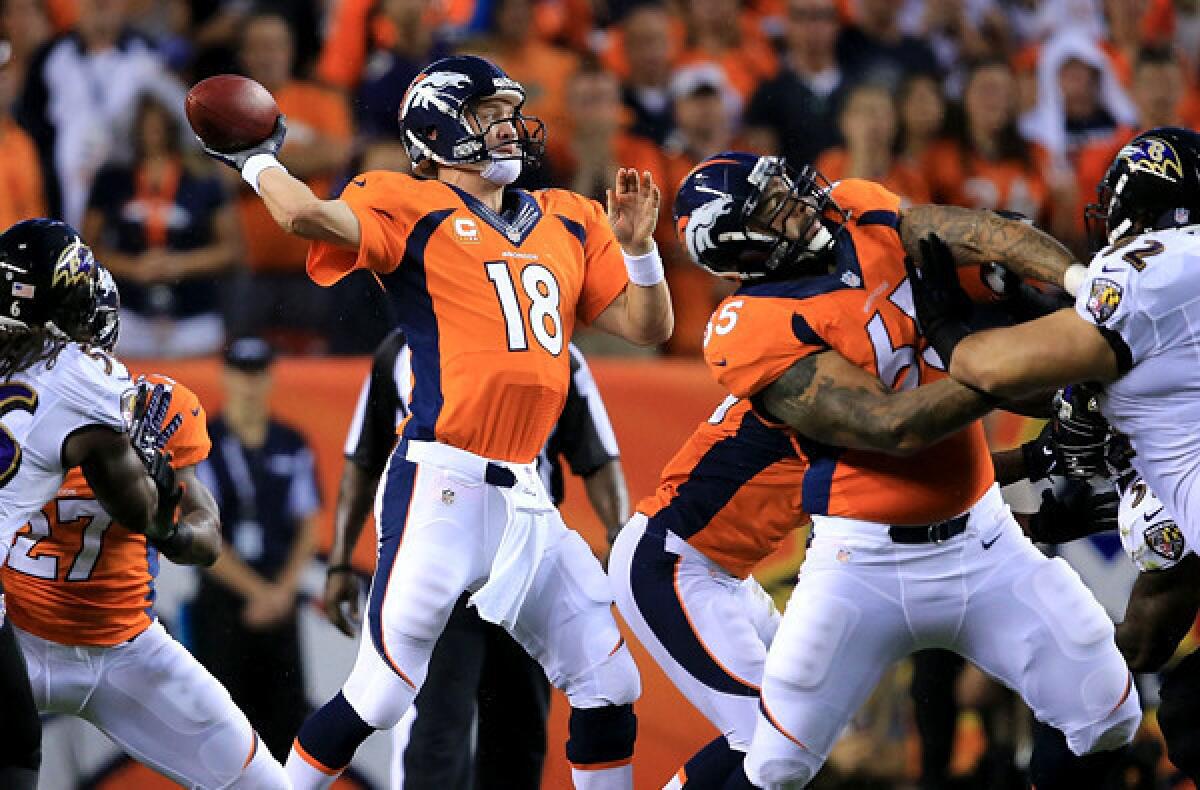 Broncos quarterback Peyton Manning (19) fires a pass against a strong rush by the Ravens during their season-opening game Thursday night in Denver.