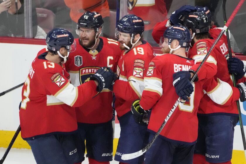 Florida Panthers left wing Matthew Tkachuk (19) is congratulated by his teammates after he scored to tie the game in the third period of Game 3 of the NHL hockey Stanley Cup Finals against the Vegas Golden Knights, Thursday, June 8, 2023, in Sunrise, Fla. (AP Photo/Rebecca Blackwell)