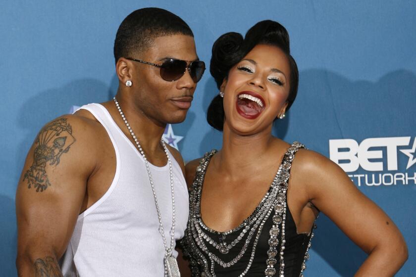 Rapper Nelly, left, and Ashanti pose backstage at the BET Awards in 2008
