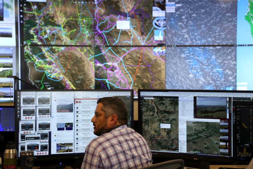 SAN FRANCISCO, CALIFORNIA - AUGUST 05: Pacific Gas and Electric (PG&E) Senior Wildfire Operations Center Analyst Anthony Malnati sits in front of video screens and computer monitors at he PG&E Wildfire Safety Operations Center on August 05, 2019 in San Francisco, California. PG&E opened up its Wildfire Safety Operations Center earlier this year that will monitor potential wildfire threats throughout its service area. The office will be staffed 24 hours a to help coordinate with public safety officials and first responders when wildfires start. (Photo by Justin Sullivan/Getty Images)