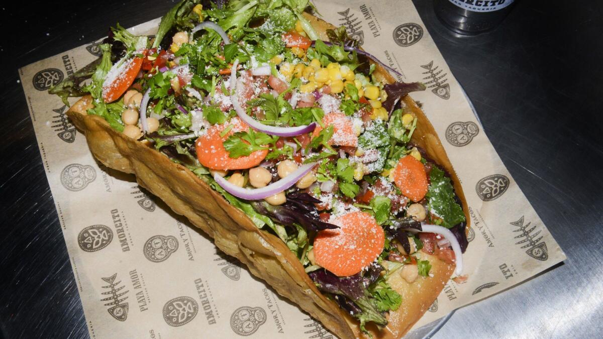 The taco salad at Amorcito is served in an oversize, taco-shaped shell.
