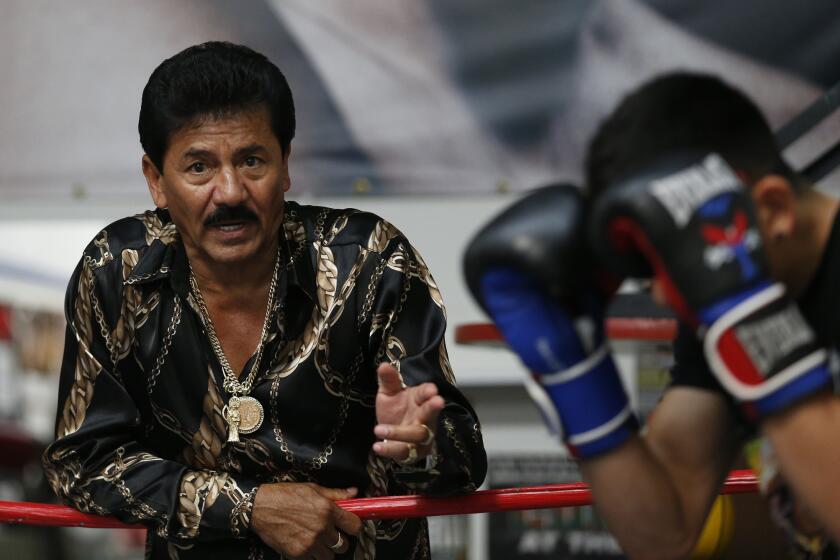 Jose Santa Cruz, left, trains his son, boxer Leo Santa Cruz, on Aug. 20.