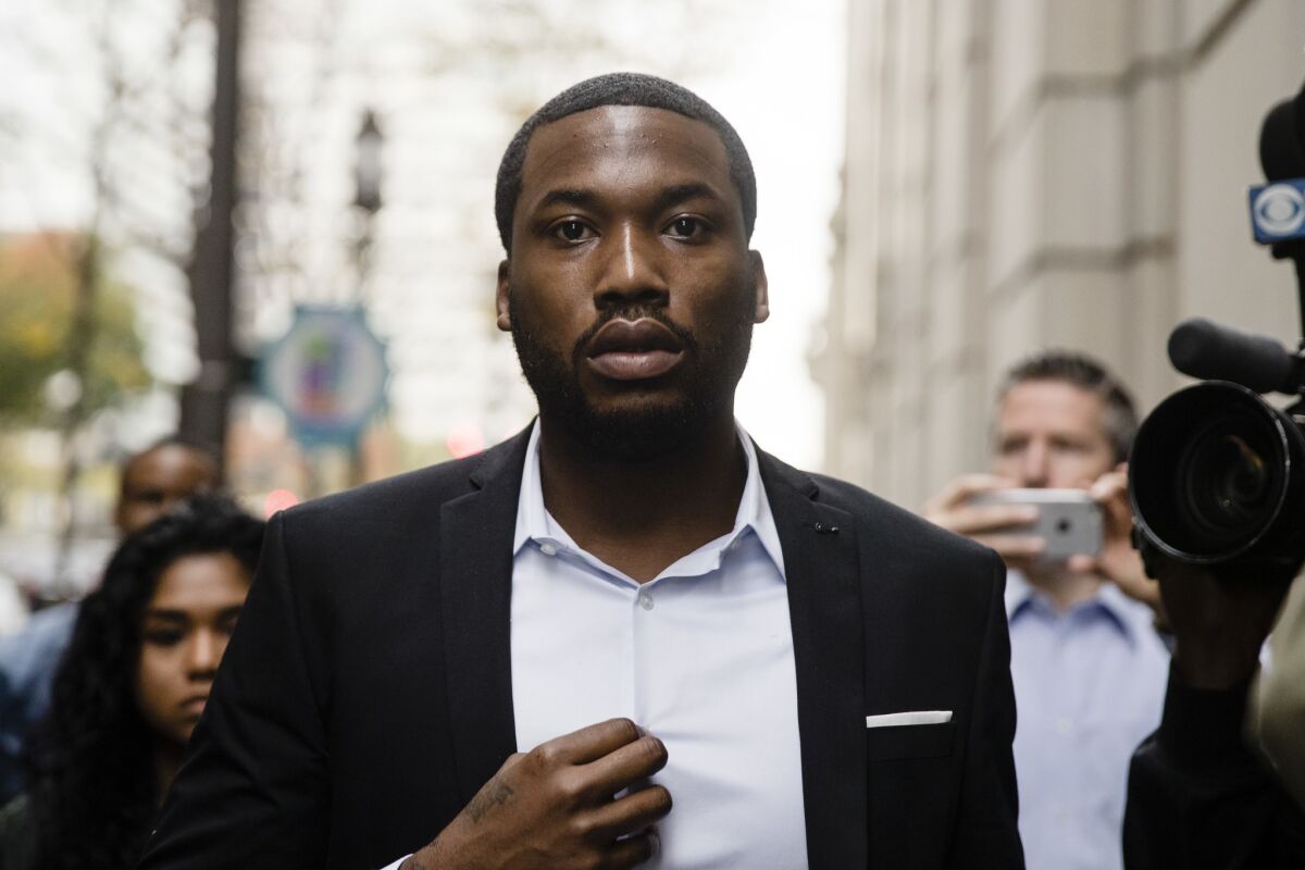 Meek Mill arrives at the criminal justice center in Philadelphia. A Philadelphia judge has sentenced rapper Mill to two to four years in state prison for violating probation in a nearly decade-old gun and drug case.