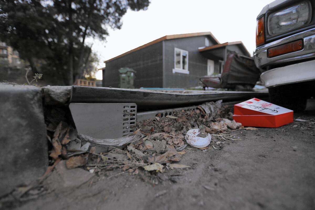 A mix of garbage and debris blocks a catch basin in Boyle Heights. Blocked drains could become a public safety hazard during El Niño rains.