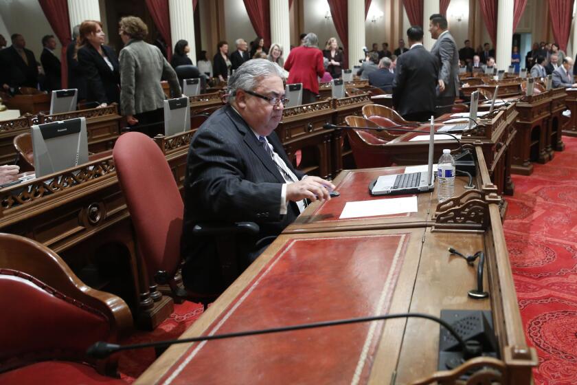 State Sen. Ron Calderon, D-Montebello, sits at his desk during a Senate session in January.