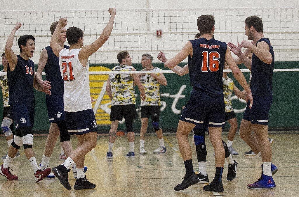 The Orange Coast College men's volleyball team celebrates its win over Golden West.