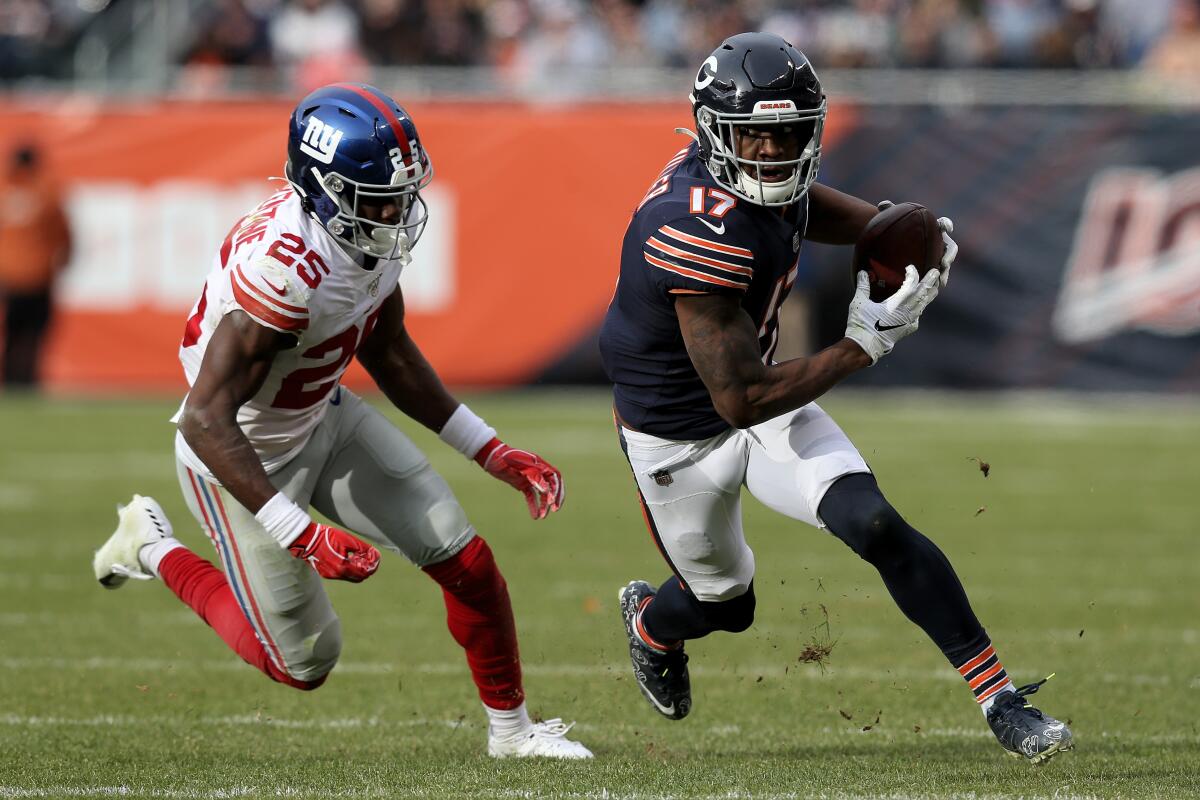 Chicago Bears wide receiver Anthony Miller runs with the ball while being chased by Giants cornerback Corey Ballentine.