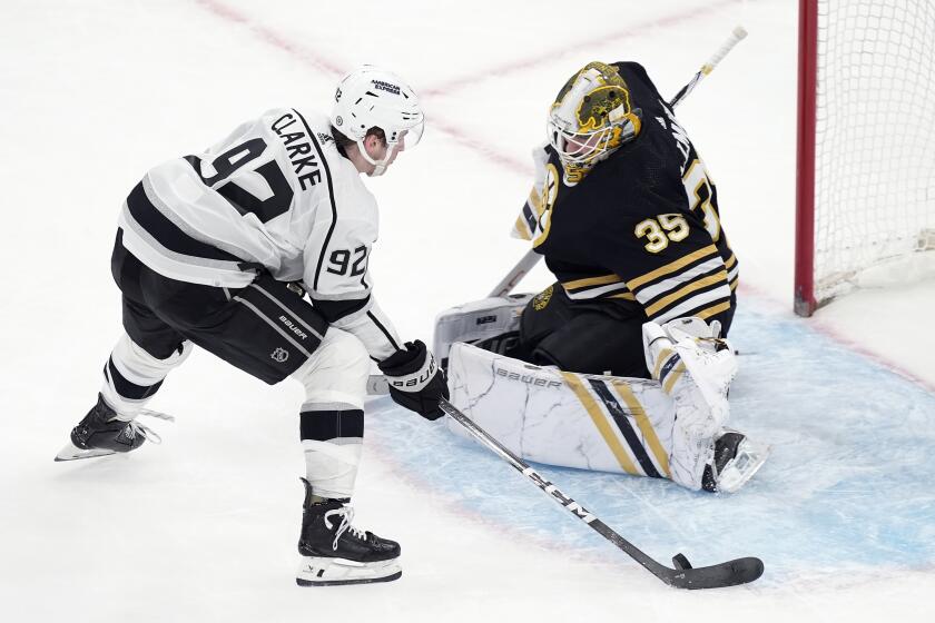 Los Angeles Kings' Brandt Clarke (92) sets up to score on Boston Bruins' Linus Ullmark.