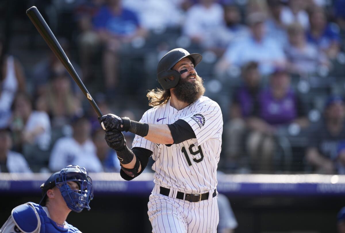 Colorado Rockies' Charlie Blackmon follows the flight of his solo walkoff home run off Los Angeles Dodgers starting pitcher Phil Bickford in the 10th inning of a baseball game Sunday, July 18, 2021, in Denver. (AP Photo/David Zalubowski)