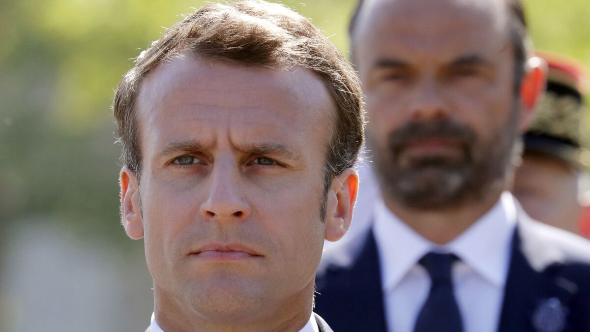 French President Emmanuel Macron, left, and Prime Minister Edouard Philippe attend a ceremony in Paris on May 8, 2018, marking 73 years since World War II ended in Europe.